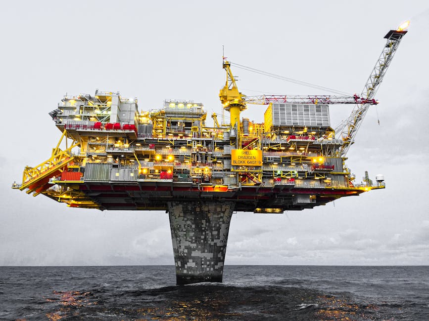 A well-lit offshore oil platform against a cloudy sky in Norway's waters.